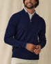 Men's Lakeside Quarter Zip Sweater in New Indigo, front view on model featuring a solid navy knit body with light blue tipped collar and cuffs, layered over a white polo, worn with light grey pants