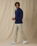 Men's Lakeside Quarter Zip Sweater in New Indigo, full front view on model featuring a solid navy knit body with light blue tipped collar and cuffs, layered over a white polo, worn with light grey pants and white golf shoes