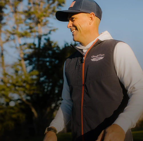Golfer in patriotic golf apparel Zephyr Hybrid Vest and cap, America 250 capsule lifestyle image