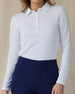 Midday Long Sleeve Polo in White, front view on model showing a fitted collared long sleeve polo with a half-button neckline, paired with navy pants