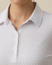 Close-up detail of the Roses Long Sleeve Polo in Cosmic showcasing the white base fabric and pastel rose print