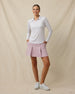 Full outfit view of the Roses Long Sleeve Polo in Cosmic worn untucked with a blush golf skort
