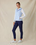 Cloud Vest in Powder, full length side view on model featuring a light blue quilted full-zip vest with mock neck collar and tonal logo detail styled with a white long sleeve top, navy pants, and white shoes
