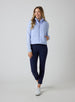 Women's Sandy Vest in Lavender, full length front view on model featuring a light purple quilted puffer vest layered over a patterned long sleeve top, paired with navy pants and white golf shoes