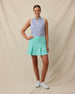 Georgia Stripe Sleeveless Polo in Tidal Blue micro stripe print tucked into mint green skort, full outfit model view