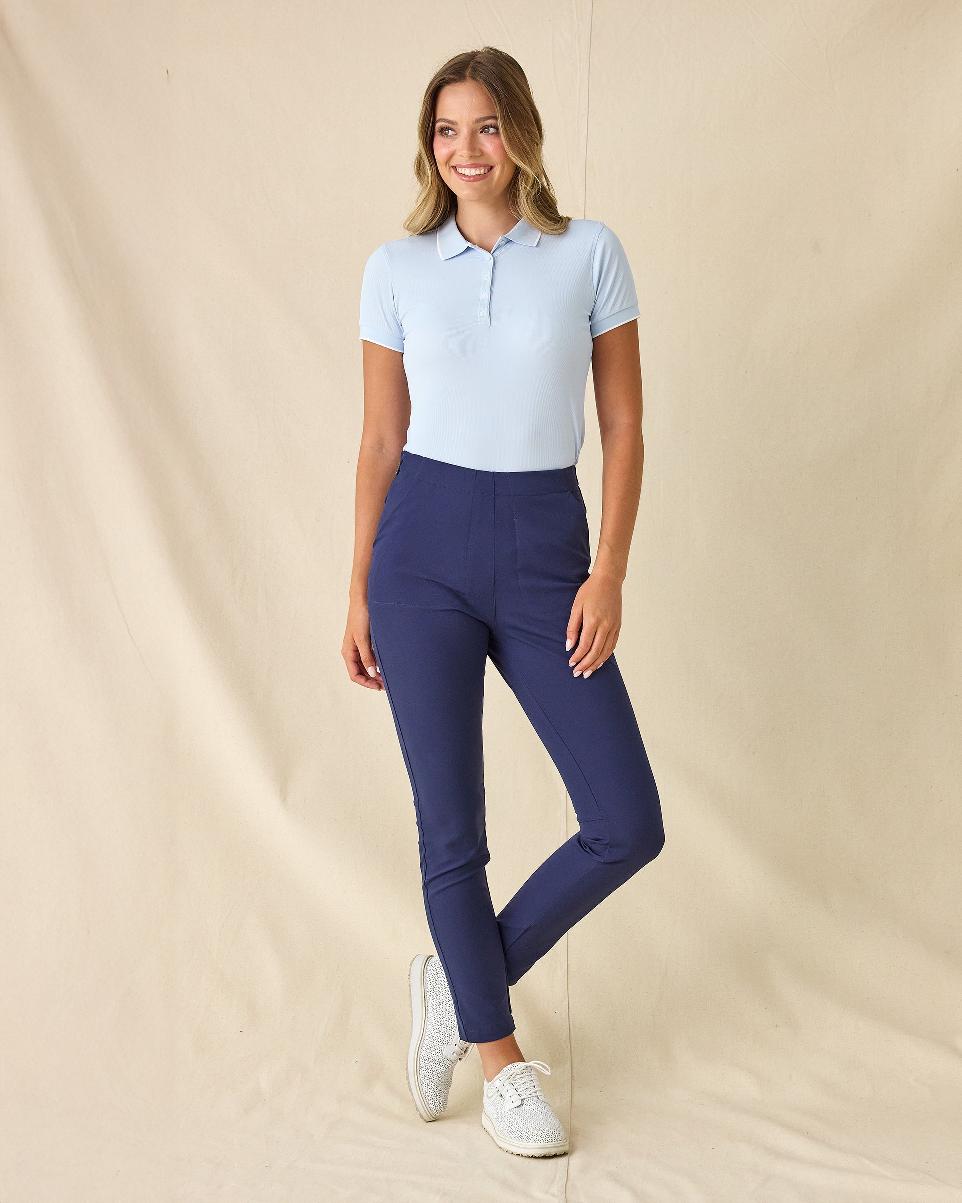 Women's Sindy Rib Knit Polo in Lake, full length front view on model featuring a ribbed knit with white tipped collar, paired with navy pants and white shoes