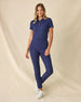 Women's Sindy Rib Knit Polo in New Indigo, full length front view on model featuring a ribbed knit with white tipped collar and cuffs, paired with navy pants and white shoes