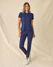 Women's Sindy Rib Knit Polo in New Indigo, full length front view on model featuring a ribbed knit with white tipped collar and cuffs, paired with navy pants and white shoes