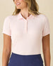 Women's Sindy Rib Knit Polo in Pearl, front model view featuring a light pink short sleeve ribbed knit polo with a spread collar, styled with navy pants