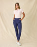 Women's Sindy Rib Knit Polo in Pearl, full length model view featuring a light pink short sleeve ribbed knit polo with a spread collar, styled with navy pants and white shoes