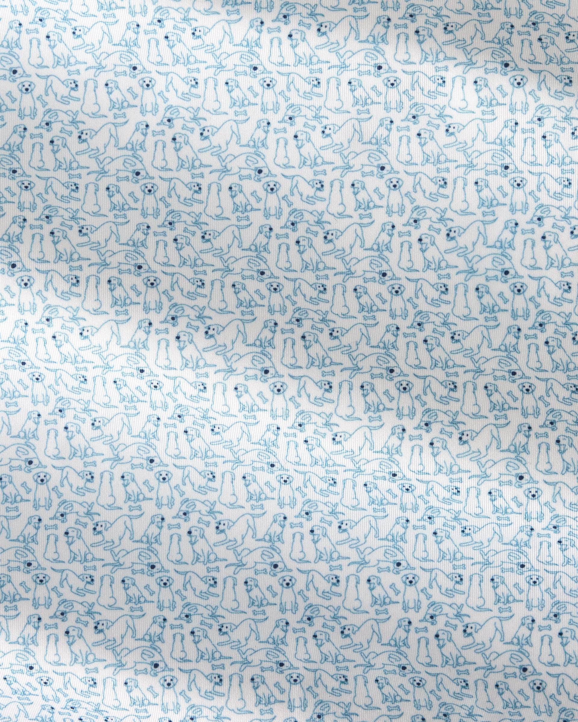 A close-up of a white fabric with a repeating light blue line-art pattern of small dogs in various poses.