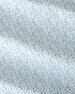 A close-up of a white fabric with a repeating light blue line-art pattern of small dogs in various poses.