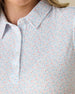 Spring Valley Polo in Spritz, close-up detail view featuring light blue floral vine and coral dot print on a white base with pearl buttons