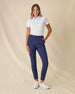 Spring Valley Polo in Spritz, full length side angle view featuring a white base with light blue floral vine and coral dot allover print pattern, paired with navy ankle pants and white golf shoes