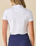 Women's Mariette Polo in Pink Floyd, back view on model featuring an allover blue and purple vine floral print with tonal Straight Down logo embroidered at center back neck, paired with navy pants