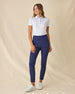 Women's Mariette Polo in Pink Floyd, full length front view on model featuring an allover blue and purple vine floral print, paired with navy pants and white shoes