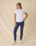 Women's Mariette Polo in Pink Floyd, full length front view on model featuring an allover blue and purple vine floral print, paired with navy pants and white shoes