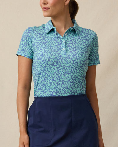 Huli Polo in Tidal Blue with tropical leaf print, front view