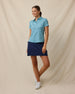 Huli Polo in Tidal Blue styled with navy skort, full outfit view