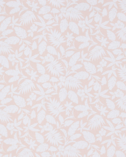 Close-up of the Huli Polo in Peach fabric featuring a tonal peach and white print of tropical leaves and flowers.