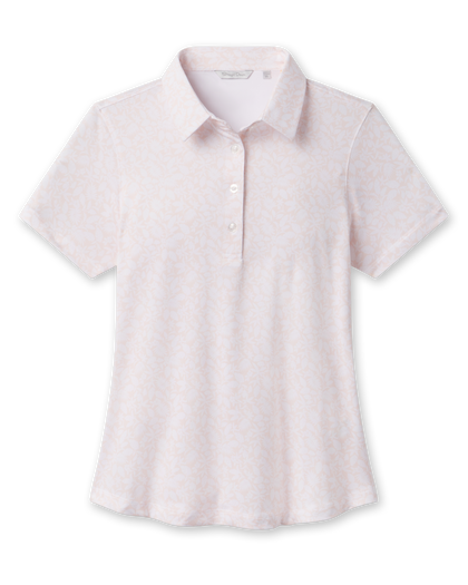 Front product view of the Huli Polo in Peach, featuring a soft peach and white floral print, short sleeves, pointed collar, and three-button placket.