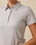 Close-up of the Martini Girl Polo in Lemongrass showing the pointed collar, button placket, short sleeve, and miniature martini glass print.