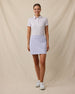 Full outfit view of the Wonderland Polo in White tucked into a lavender golf skort