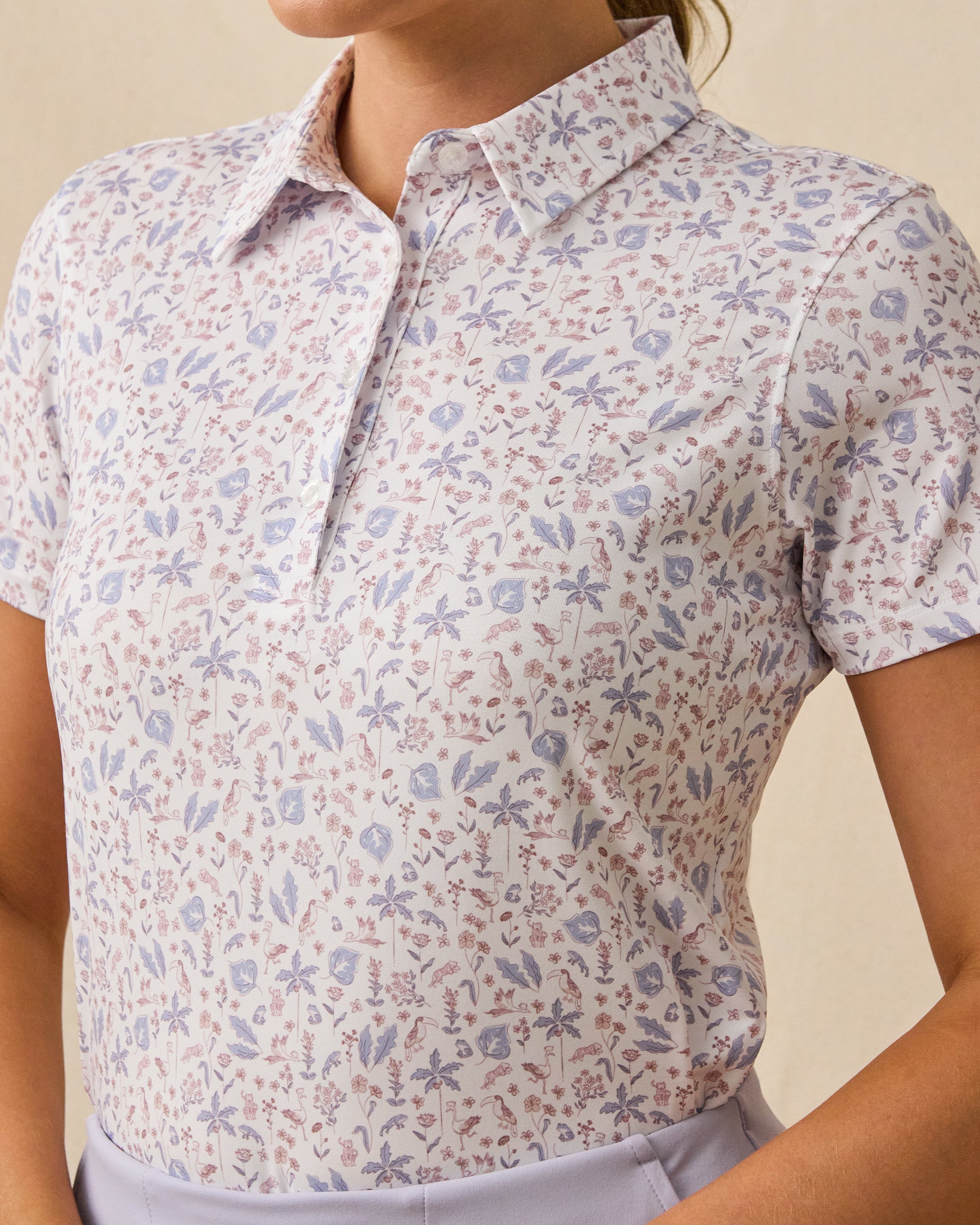 Close-up detail of the Wonderland Polo in White featuring an allover floral and botanical print