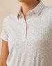 Close-up of the Palm Island Polo in Lemongrass showing the collar, button placket, and pastel tropical print.