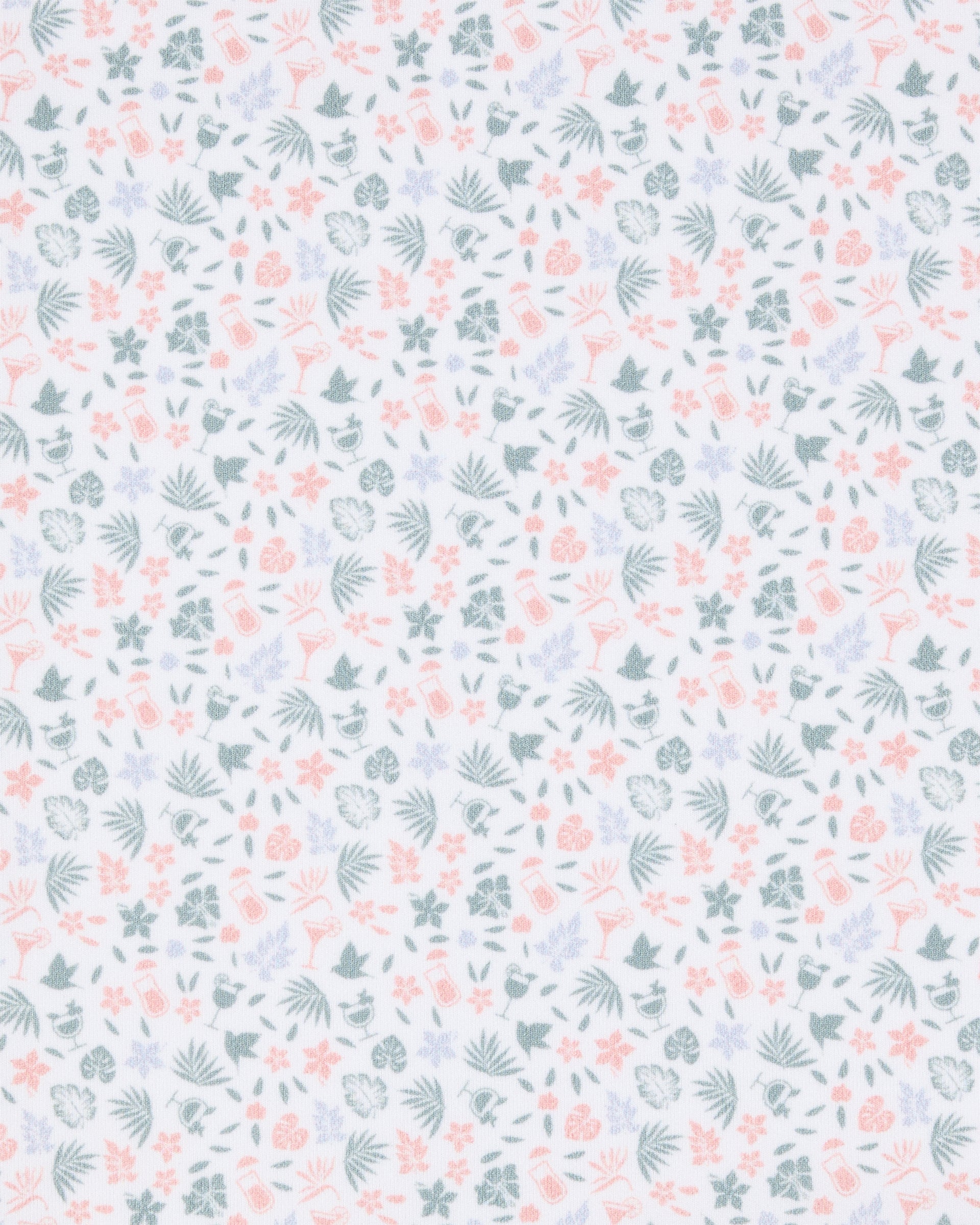 Close-up of the Palm Island Polo in Lemongrass fabric featuring a pastel print of palm leaves, flowers, tropical foliage, and cocktail motifs.