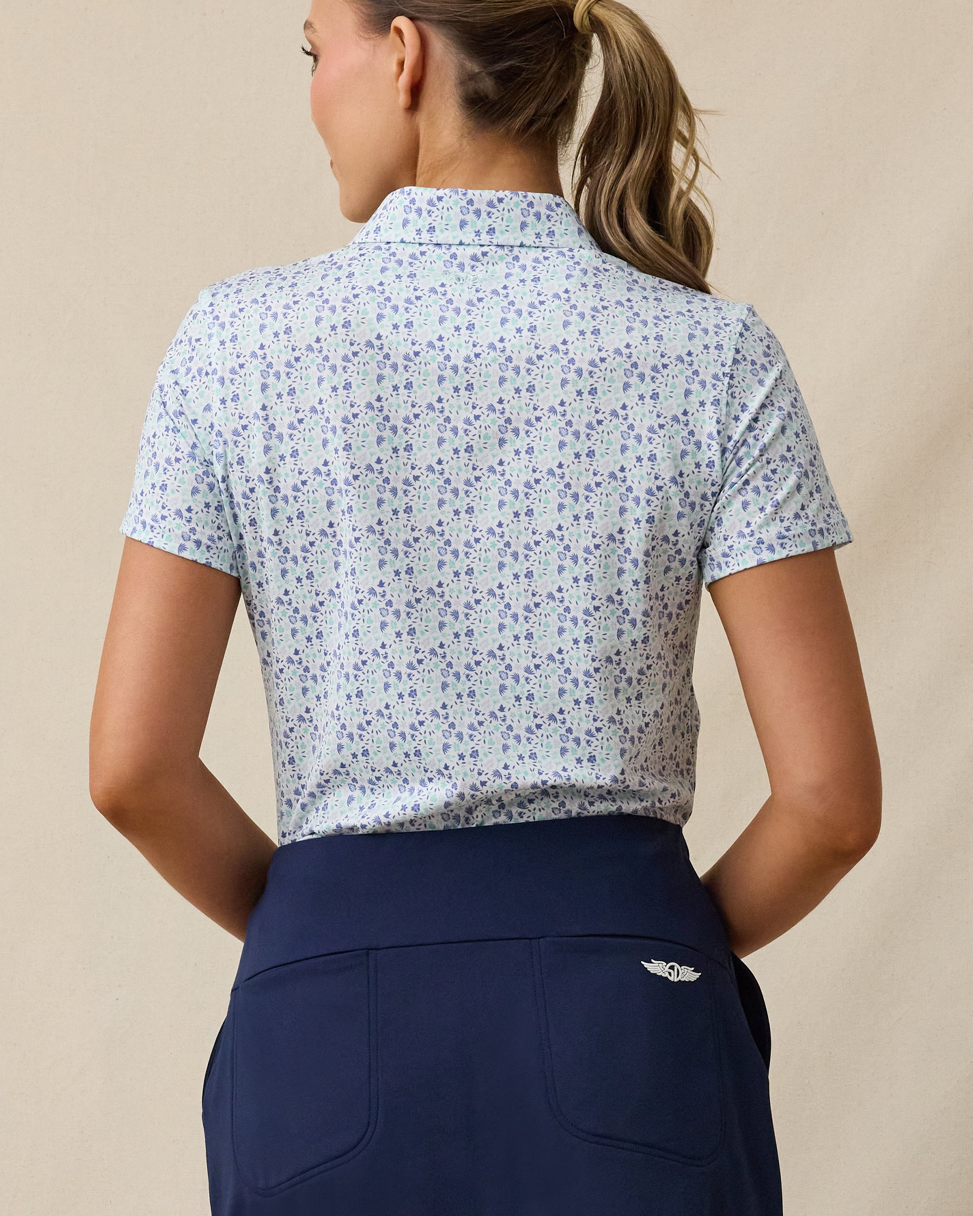 Palm Island Polo in Tidal blue with tropical floral print, back model view