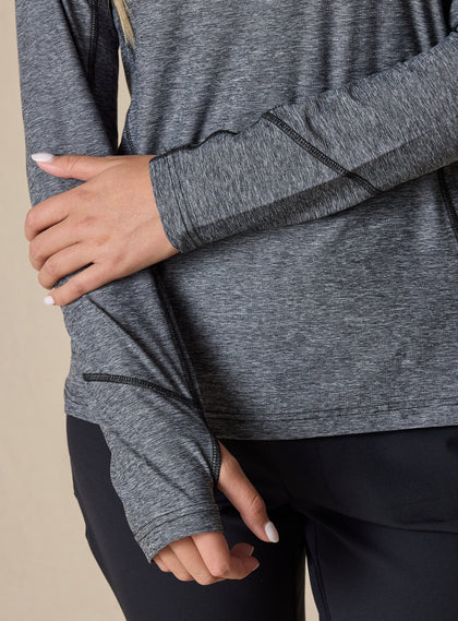 Straight Down Women's Claire Quarter Zip in Black, close up detail view highlighting the contrast black seam detailing and thumb hole cuffs