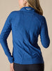 Straight Down Women's Claire Quarter Zip in Indigo, back view on model featuring a heathered blue long sleeve quarter zip pullover with the Straight Down logo at the back collar, paired with black pants