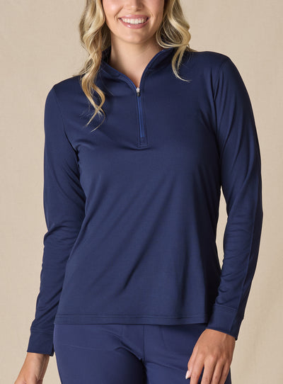 Women's Aero Quarter Zip in New Indigo, front view on model featuring a navy micro-texture long sleeve pullover with a quarter-zip neckline paired with navy pants