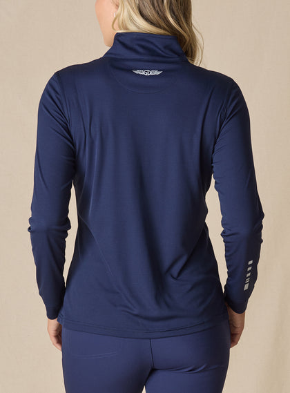 Women's Aero Quarter Zip in New Indigo, back view on model featuring a navy micro-texture long sleeve pullover with an embroidered Straight Down logo at the collar and white sleeve accent detail paired with navy pants