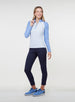Full-body view of a woman wearing a light blue quarter-zip pullover with contrasting blue raglan sleeves, navy pants, and blue shoes

