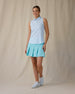 Women's Costa Rica Sleeveless Polo in Green Stone, full-length front on-model view featuring a white sleeveless polo with an allover small floral and leaf print in blue and mint green tones, spread collar, and three-button placket, paired with a mint green pleated skirt and white shoes