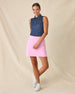 Cherry Bloom Sleeveless Polo in New Indigo, full-length front view on model featuring a navy base with scattered white and pink floral print, paired with a pink skort and white golf shoes