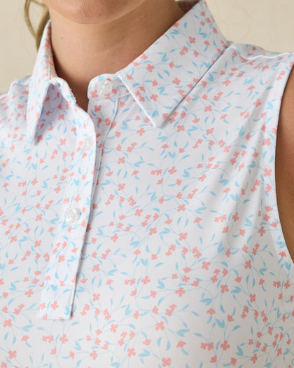 Valerie Sleeveless Polo in Spritz, close-up detail view featuring coral floral and light blue vine print on a white base with pearl buttons
