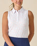 Valerie Sleeveless Polo in Spritz, front view featuring a white base with coral floral and light blue vine allover print pattern, paired with navy shorts