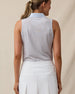 Back view of a woman wearing the Milano Sleeveless Polo in Lake with a white skort, featuring the allover geometric print, light blue contrast collar, and embroidered logo below the back collar.
