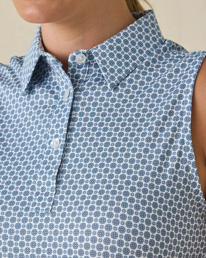 Milano Sleeveless Polo in Gemstone, close-up detail view featuring navy geometric medallion print on a white base with pearl buttons