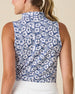 Moloka'i Sleeveless Polo in Moonlight, back view on model featuring a slate blue base with a white hibiscus and tropical leaf print, paired with a white skort
