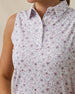 Close-up of the Women's Erika Sleeveless Polo in White featuring an intricate floral vine pattern in soft pink and lavender tones