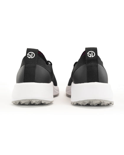 Swing Shoe in Black, back view of a pair featuring the black heel cap, Straight Down logo pull tab, white midsole, and grey traction outsole