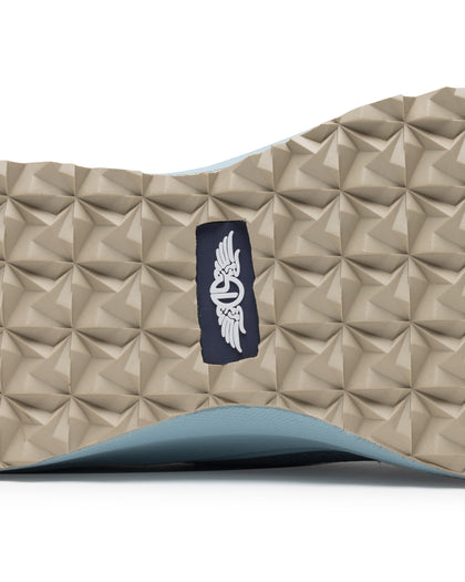 Swing Shoe in Mineral, close-up bottom view featuring the tan geometric traction outsole with Straight Down navy logo label at the center and light blue midsole edge