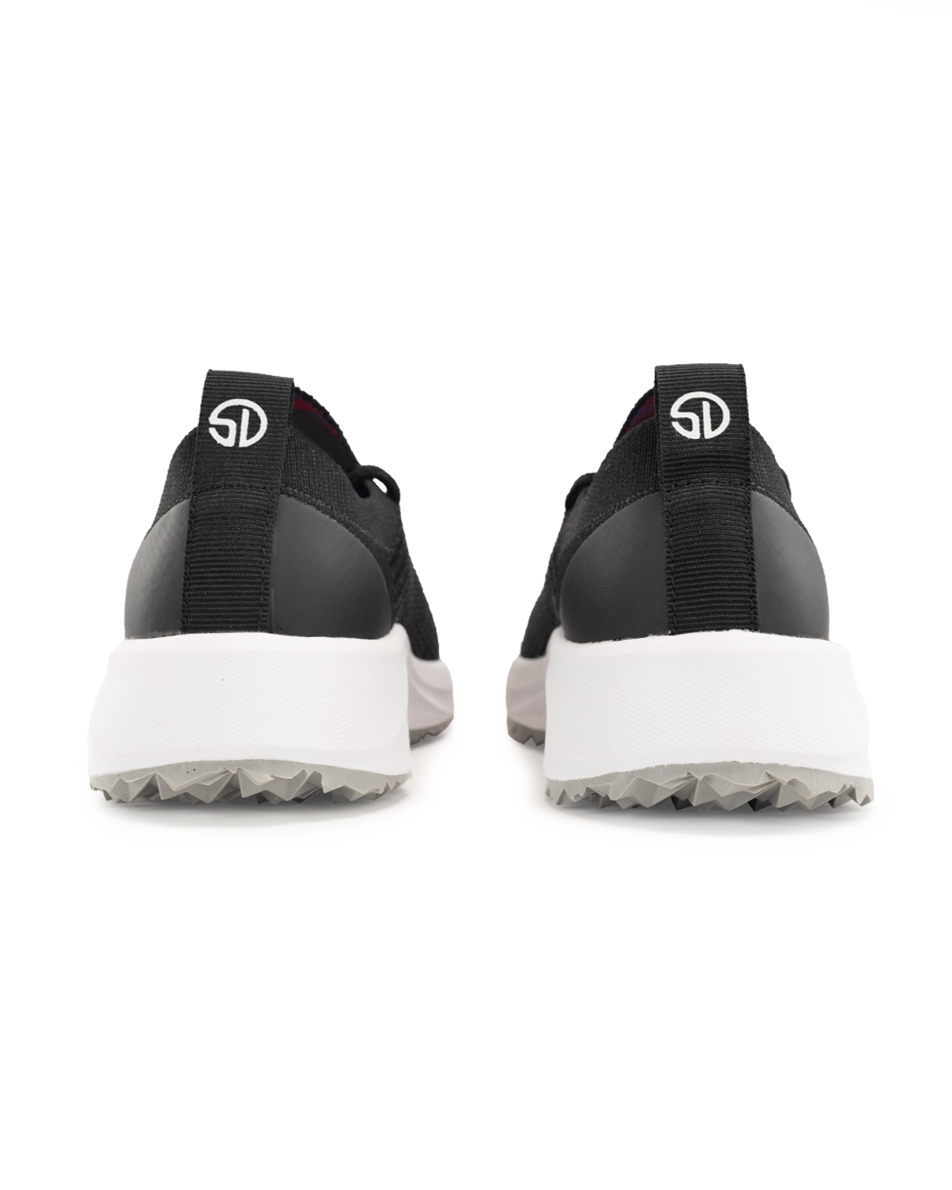 Swing Shoe in Black, back view of a pair featuring the black heel cap, Straight Down logo pull tab, white midsole, and grey traction outsole