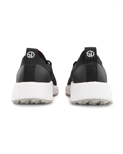 Swing Shoe in Black, back view of a pair featuring the black heel cap, Straight Down logo pull tab, white midsole, and grey traction outsole