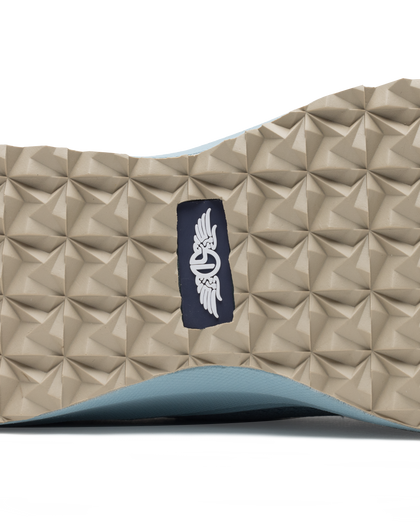 Swing Shoe in Mineral, close-up bottom view featuring the tan geometric traction outsole with Straight Down navy logo label at the center and light blue midsole edge