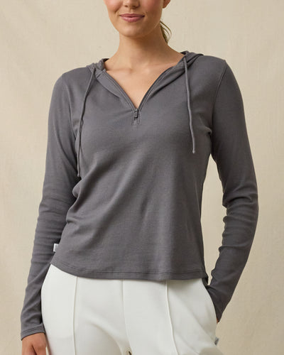 Front view of a woman wearing the Thyme Hoodie in Nightshade, showing the half-zip neckline, drawstring hood, and ribbed texture.